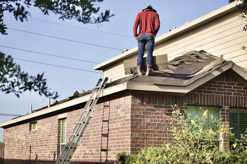 Professional roofer working on a residential roof in Homestead Hills